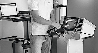 A service technician is explaining and showing features on Erbe workstation.