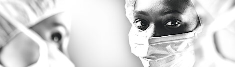 Female edoscopy nurse wearing a surgical cap and a face mask.